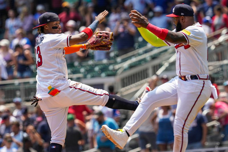 Jun 28, 2023; Cumberland, Georgia, USA; Atlanta Braves right fielder Ronald Acuna Jr. (13) reacts with designated hitter Marcell Ozuna (20) after the Braves defeated the Minnesota Twins at Truist Park. Mandatory Credit: Dale Zanine-USA TODAY Sports