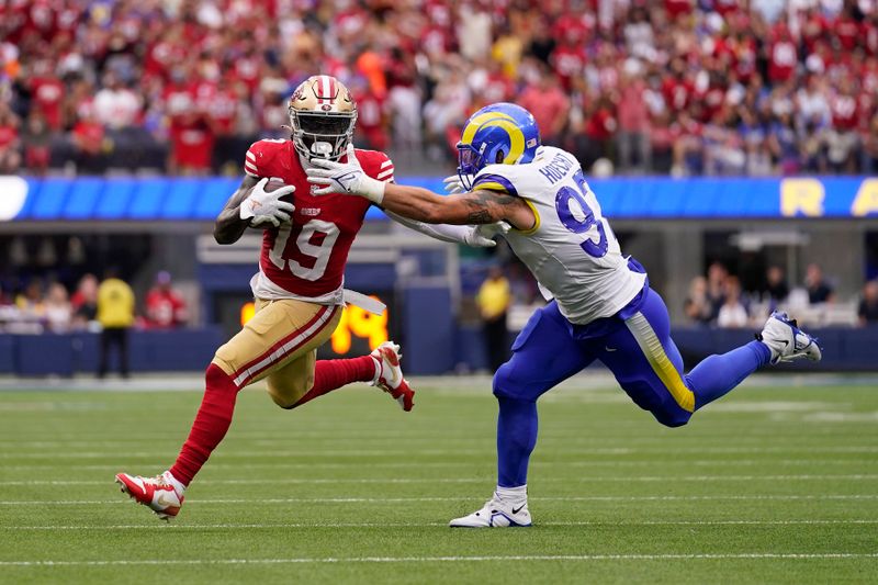 San Francisco 49ers wide receiver Deebo Samuel, left, tries to fend off Los Angeles Rams linebacker Michael Hoecht during the second half of an NFL football game Sunday, Sept. 17, 2023, in Inglewood, Calif. (AP Photo/Ashley Landis)