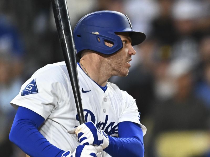 May 17, 2025; Los Angeles, California, USA; Los Angeles Dodgers first baseman Freddie Freeman (5) singles against the Los Angeles Angels during the fifth inning at Dodger Stadium. Mandatory Credit: Jonathan Hui-Imagn Images
