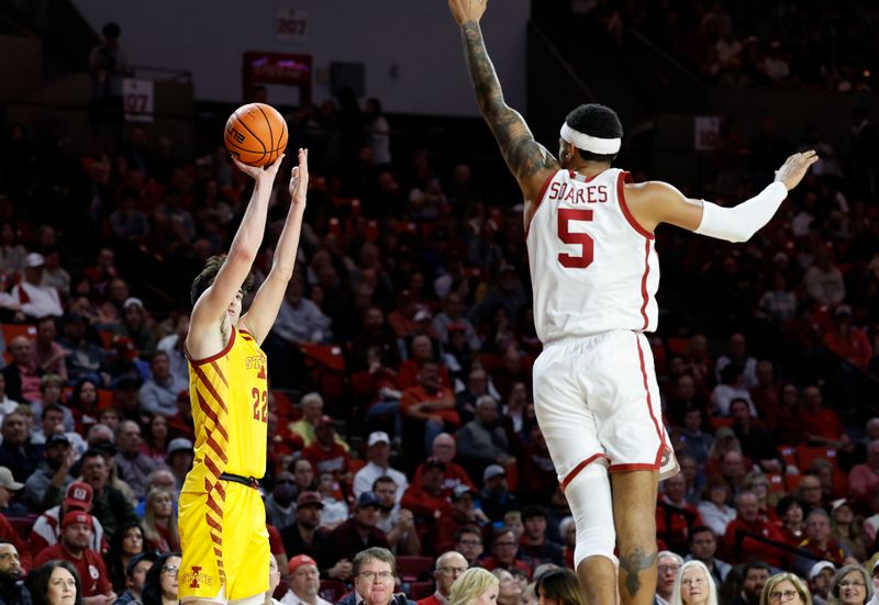 Jan 6, 2024; Norman, Oklahoma, USA; Iowa State Cyclones forward Milan Momcilovic (22) shoots a three point basket as Oklahoma Sooners guard Rivaldo Soares (5) comes in to defend during the first half at Lloyd Noble Center. Mandatory Credit: Alonzo Adams-USA TODAY Sports