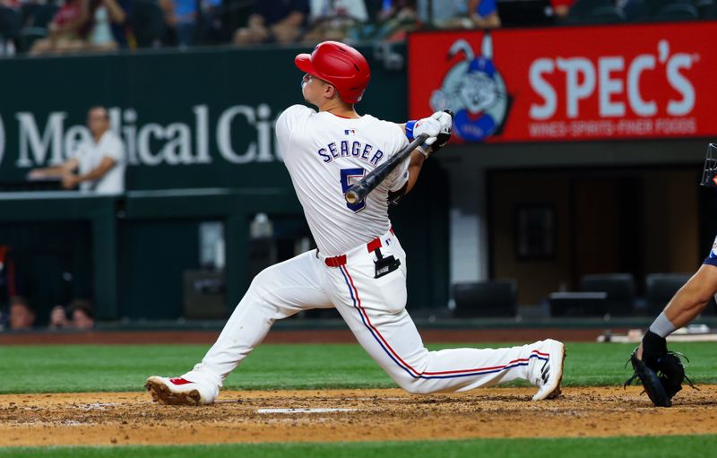 Aug 6, 2024; Arlington, Texas, USA; Texas Rangers shortstop Corey Seager (5) hits a two-run home run during the ninth inning against the Houston Astros at Globe Life Field. Mandatory Credit: Kevin Jairaj-USA TODAY Sports