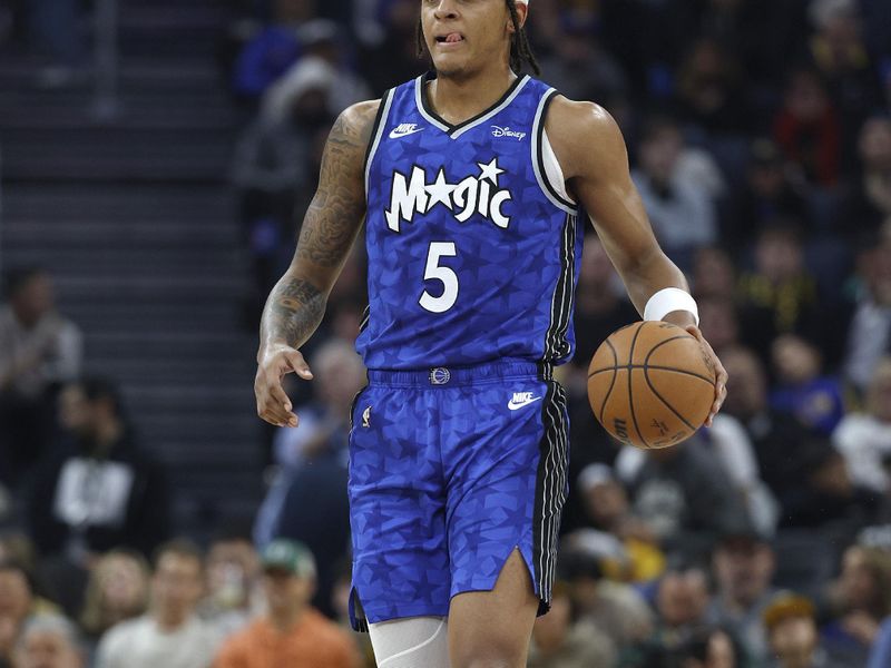 SAN FRANCISCO, CALIFORNIA - JANUARY 02: Paolo Banchero #5 of the Orlando Magic dribbles the ball up court against the Golden State Warriors during the first quarter of an NBA basketball game at Chase Center on January 02, 2024 in San Francisco, California. NOTE TO USER: User expressly acknowledges and agrees that, by downloading and or using this photograph, User is consenting to the terms and conditions of the Getty Images License Agreement. (Photo by Thearon W. Henderson/Getty Images)