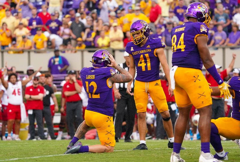 Sep 3, 2022; Greenville, North Carolina, USA;  East Carolina Pirates punter Luke Larsen (12) reacts to place kicker Owen Daffer (41) missed extra point against the North Carolina State Wolfpack during the second half at Dowdy-Ficklen Stadium. Mandatory Credit: James Guillory-USA TODAY Sports