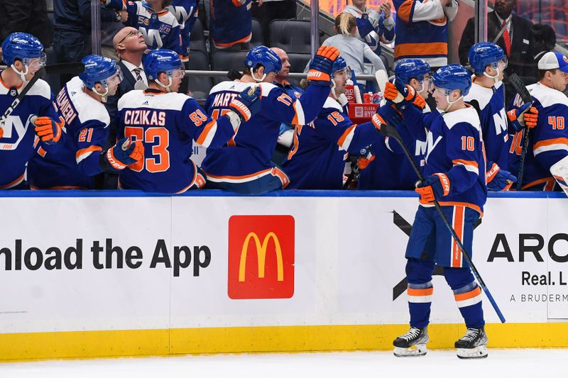 Apr 6, 2023; Elmont, New York, USA; New York Islanders right wing Simon Holmstrom (10) celebrates his goal against the Tampa Bay Lightning with the New York Islanders bench during the third period at UBS Arena. Mandatory Credit: Dennis Schneidler-USA TODAY Sports