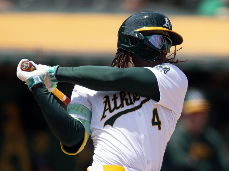 Jun 20, 2024; Oakland, California, USA; Oakland Athletics right fielder Lawrence Butler (4) follows the flight of his double against the Kansas City Royals during the seventh inning at Oakland-Alameda County Coliseum. Mandatory Credit: D. Ross Cameron-USA TODAY Sports