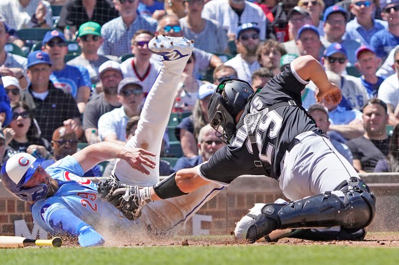 May 16, 2025; Chicago, Illinois, USA; Chicago Cubs first base Michael Busch (29) is safe at home plate as Chicago White Sox catcher Matt Thaiss (29) makes a tag during the second inning at Wrigley Field. Mandatory Credit: David Banks-Imagn Images