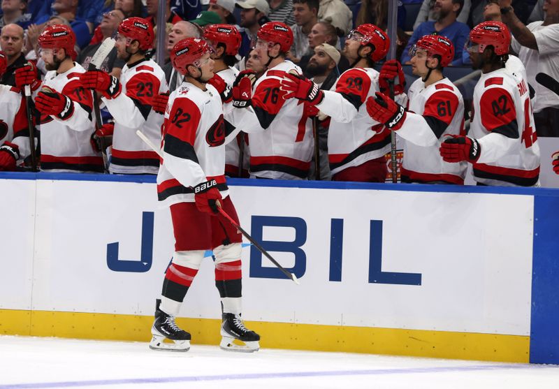 Sep 26, 2025; Tampa, Florida, USA; Carolina Hurricanes center Jesperi Kotkaniemi (82) is congratulated after he scored a goal against the Tampa Bay Lightning during the third period at Benchmark International Arena. Mandatory Credit: Kim Klement Neitzel-Imagn Images