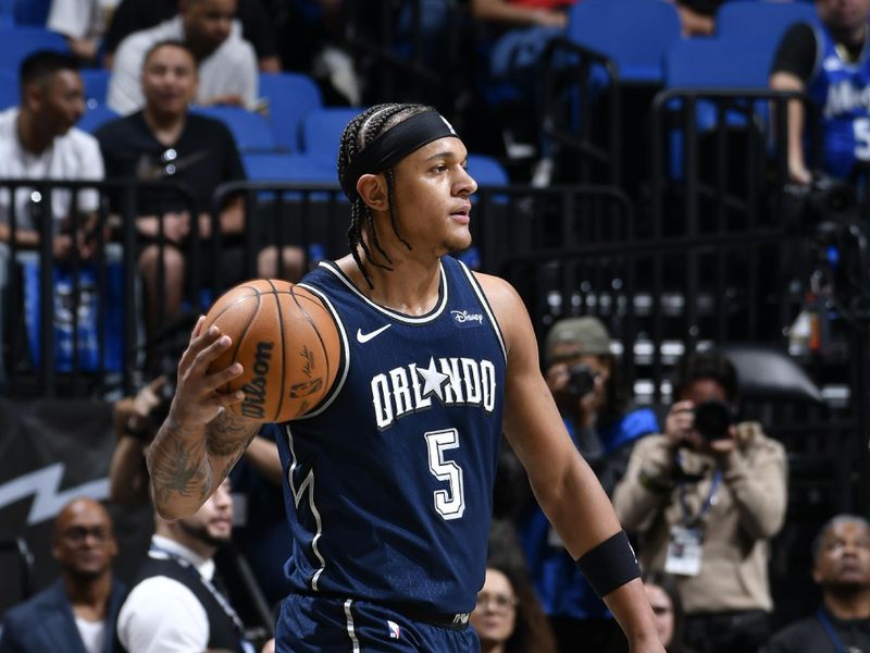 ORLANDO, FL - MARCH 21: Paolo Banchero #5 of the Orlando Magic looks to pass the ball during the game against the New Orleans Pelicans on March 21, 2024 at Amway Center in Orlando, Florida. NOTE TO USER: User expressly acknowledges and agrees that, by downloading and or using this photograph, User is consenting to the terms and conditions of the Getty Images License Agreement. Mandatory Copyright Notice: Copyright 2024 NBAE (Photo by Fernando Medina/NBAE via Getty Images)