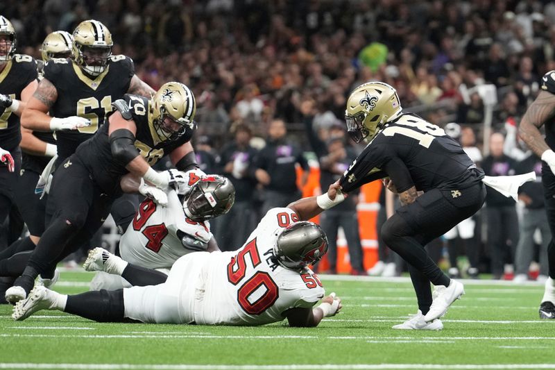 Tampa Bay Buccaneers defensive tackle Vita Vea (50) pulls down New Orleans Saints quarterback Spencer Rattler (18) by his jersey to prevent a first down during an NFL football game, Sunday, October. 13, 2024, in New Orleans, LA. (AP Photo/Peter Joneleit)