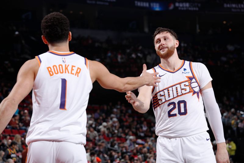 PORTLAND, OR - JANUARY 14: Devin Booker #1 high fives Jusuf Nurkic #20 of the Phoenix Suns during the game against the Portland Trail Blazers on January 14, 2024 at the Moda Center Arena in Portland, Oregon. NOTE TO USER: User expressly acknowledges and agrees that, by downloading and or using this photograph, user is consenting to the terms and conditions of the Getty Images License Agreement. Mandatory Copyright Notice: Copyright 2024 NBAE (Photo by Cameron Browne/NBAE via Getty Images)