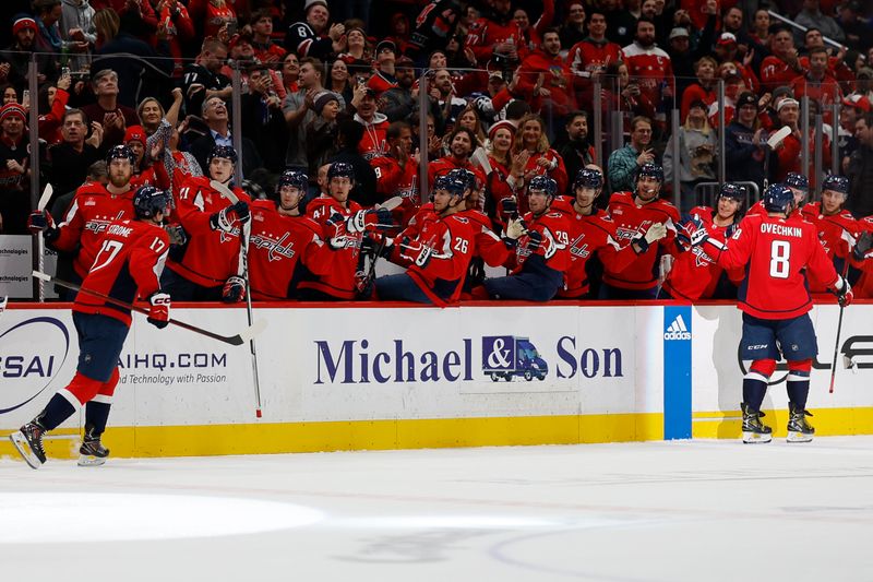 Jan 5, 2024; Washington, District of Columbia, USA; Washington Capitals center Dylan Strome (17) celebrates with teammates after scoring a goal against the Carolina Hurricanes in the first period at Capital One Arena. Mandatory Credit: Geoff Burke-USA TODAY Sports