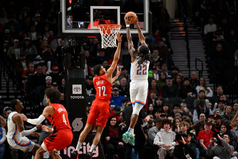 PORTLAND, OREGON - MARCH 06: Cason Wallace #22 of the Oklahoma City Thunder dunks over Rayan Rupert #72 of the Portland Trail Blazers during the second quarter of the game at the Moda Center on March 06, 2024 in Portland, Oregon. NOTE TO USER: User expressly acknowledges and agrees that, by downloading and or using this photograph, User is consenting to the terms and conditions of the Getty Images License Agreement. (Photo by Alika Jenner/Getty Images)