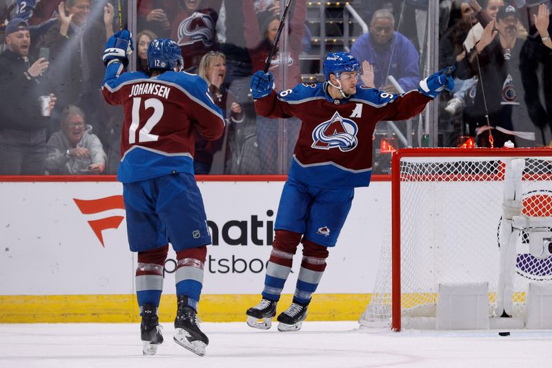 Nov 7, 2023; Denver, Colorado, USA; Colorado Avalanche right wing Mikko Rantanen (96) celebrates his goal with center Ryan Johansen (12) in the first period against the New Jersey Devils at Ball Arena. Mandatory Credit: Isaiah J. Downing-USA TODAY Sports