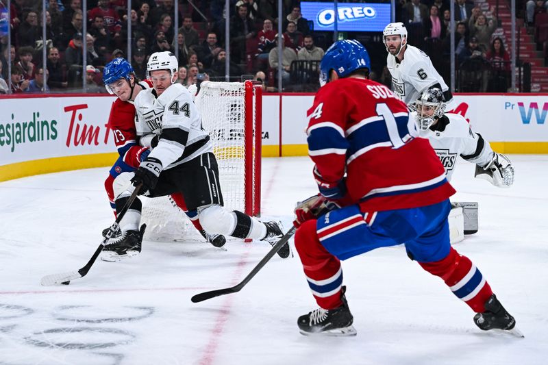 Nov 11, 2025; Montreal, Quebec, CAN; Los Angeles Kings defenseman Mikey Anderson (44) defends the puck against Montreal Canadiens right wing Cole Caufield (13) during the first period at Bell Centre. Mandatory Credit: David Kirouac-Imagn Images