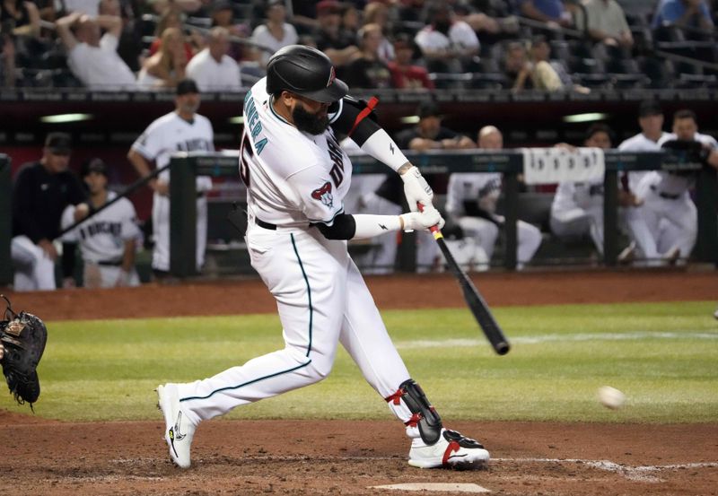 Apr 25, 2023; Phoenix, Arizona, USA; Arizona Diamondbacks pinch hitter Emmanuel Rivera (15) hits an infield single against the Kansas City Royals during the eighth inning at Chase Field. Mandatory Credit: Joe Camporeale-USA TODAY Sports