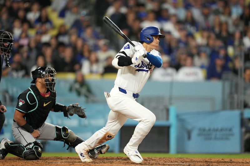 May 21, 2024; Los Angeles, California, USA; Los Angeles Dodgers designated hitter Shohei Ohtani (17) hits a single in the sixth inning against the Arizona Diamondbacks at Dodger Stadium. Mandatory Credit: Kirby Lee-USA TODAY Sports