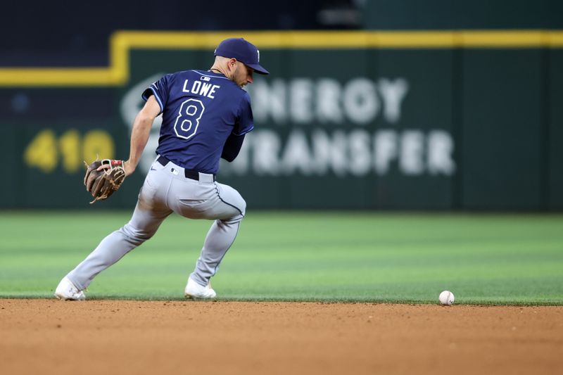 Apr 6, 2025; Arlington, Texas, USA; Tampa Bay Rays second base Brandon Lowe (8) commits an error on a ground ball during the seventh inning against the Texas Rangers at Globe Life Field. Mandatory Credit: Tim Heitman-Imagn Images