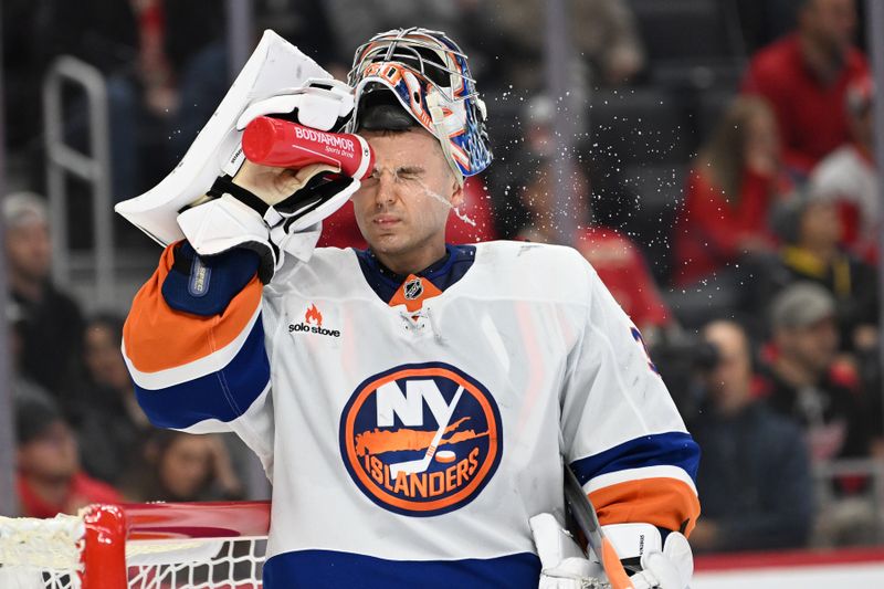 Nov 21, 2024; Detroit, Michigan, USA; New York Islanders goaltender Ilya Sorokin (30) sprays water on his face during a time out against the Detroit Red Wings in the second period at Little Caesars Arena. Mandatory Credit: Lon Horwedel-Imagn Images