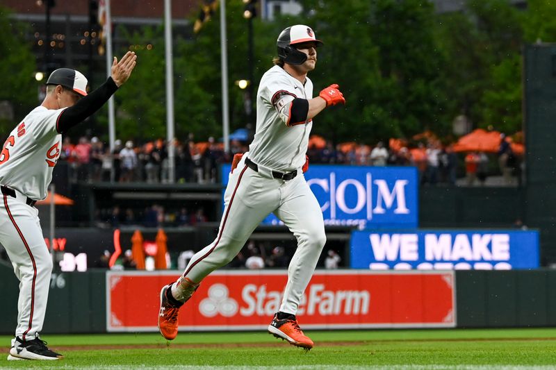 May 29, 2024; Baltimore, Maryland, USA;  Baltimore Orioles shortstop Gunnar Henderson (2) rounds third base coach Tony Mansolino (36) while celebrating a second inning grand slam against the Boston Red Sox at Oriole Park at Camden Yards. Mandatory Credit: Tommy Gilligan-USA TODAY Sports