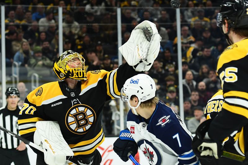 Jan 30, 2025; Boston, Massachusetts, USA; Boston Bruins goaltender Joonas Korpisalo (70) reaches for the puck over Winnipeg Jets center Vladislav Namestnikov (7) during the second period at TD Garden. Mandatory Credit: Bob DeChiara-Imagn Images