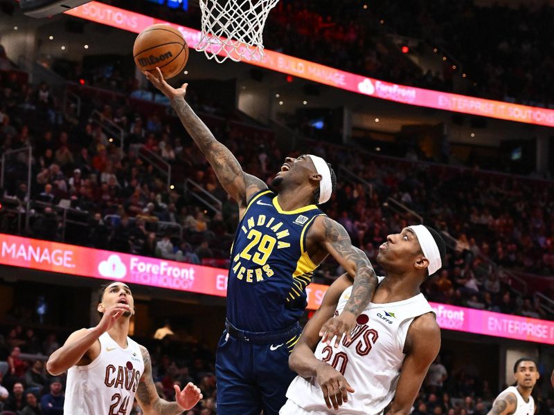 CLEVELAND, OHIO - APRIL 13: Quenton Jackson #29 of the Indiana Pacers shoots over Nae'Qwan Tomlin #30 of the Cleveland Cavaliers during overtime at Rocket Arena on April 13, 2025 in Cleveland, Ohio. The Pacers defeated the Cavaliers 126-118 in double overtime. NOTE TO USER: User expressly acknowledges and agrees that, by downloading and or using this photograph, User is consenting to the terms and conditions of the Getty Images License Agreement. (Photo by Jason Miller/Getty Images)