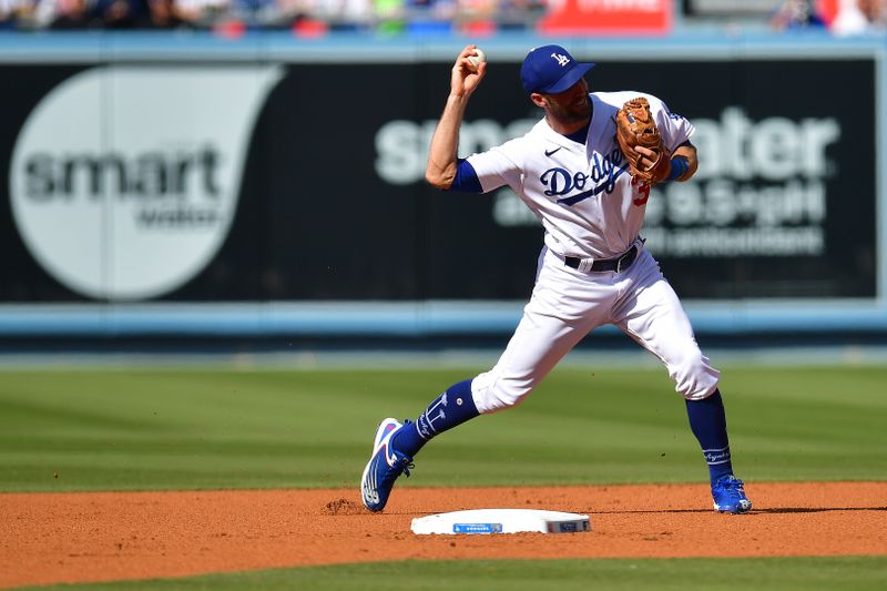 Jun 4, 2023; Los Angeles, California, USA; Los Angeles Dodgers shortstop Chris Taylor (3) throws to first for the out against New York Yankees catcher Kyle Higashioka (66) during the second inning at Dodger Stadium. Mandatory Credit: Gary A. Vasquez-USA TODAY Sports