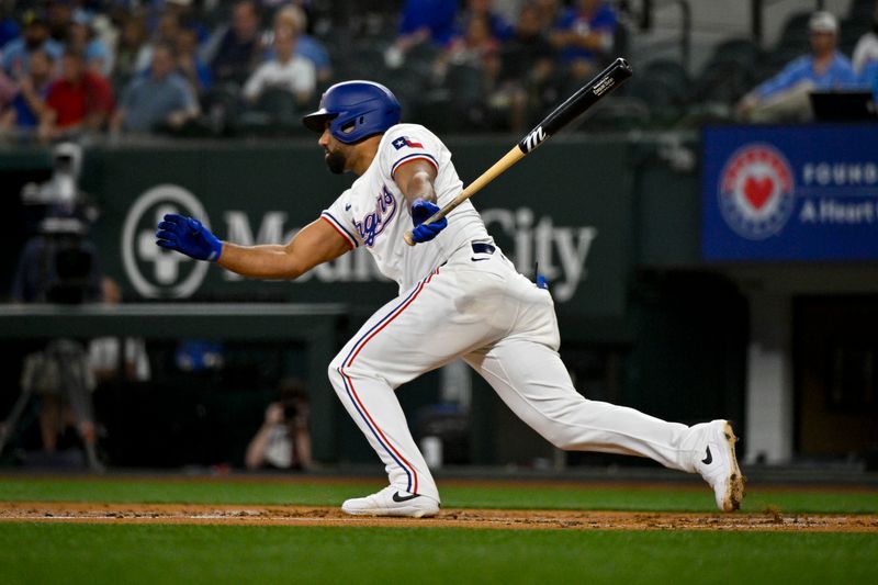 May 2, 2024; Arlington, Texas, USA; Texas Rangers designated hitter Ezequiel Duran (20) hits a double and drives in a run against the Washington Nationals during the second inning at Globe Life Field. Mandatory Credit: Jerome Miron-USA TODAY Sports