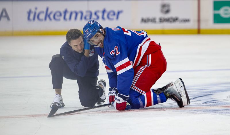 Sep 24, 2024; New York, New York, USA; New York Rangers center Filip Chytil (72) is helped on the ice by an athletic trainer after getting hit during the first period against the New York Islanders at Madison Square Garden. Mandatory Credit: Danny Wild-Imagn Images