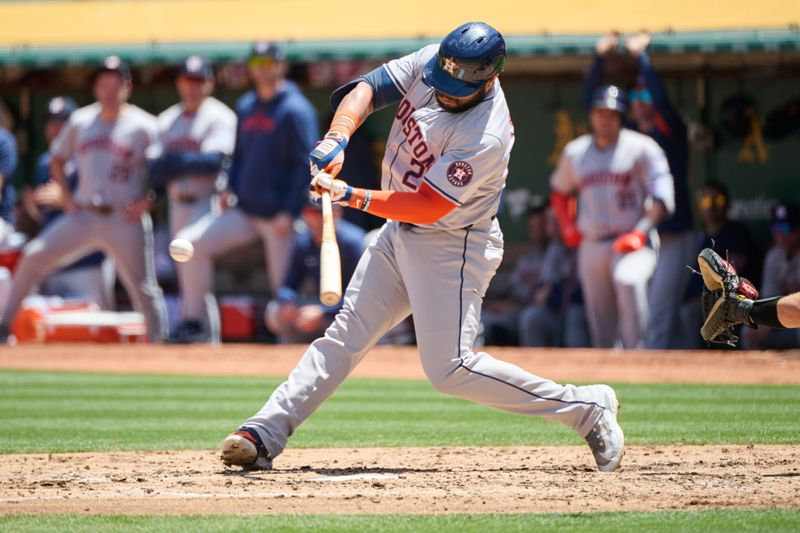 May 26, 2024; Oakland, California, USA; Houston Astros infielder Jon Singleton (28) hits a double against the Oakland Athletics during the fourth inning at Oakland-Alameda County Coliseum. Mandatory Credit: Robert Edwards-USA TODAY Sports