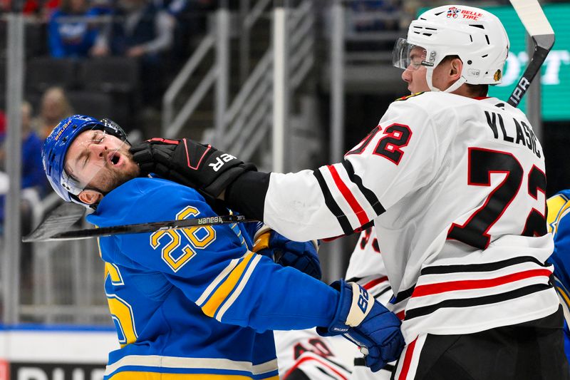 Mar 22, 2025; St. Louis, Missouri, USA;  Chicago Blackhawks defenseman Alex Vlasic (72) punches St. Louis Blues left wing Nathan Walker (26) during the second period at Enterprise Center. Mandatory Credit: Jeff Curry-Imagn Images