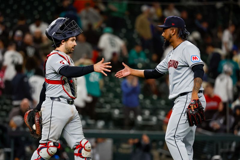 Apr 2, 2024; Seattle, Washington, USA; Cleveland Guardians relief pitcher Emmanuel Clase (48, right) shakes hands with catcher Austin Hedges (27) following the final out of the ninth inning against the Seattle Mariners at T-Mobile Park. Mandatory Credit: Joe Nicholson-USA TODAY Sports