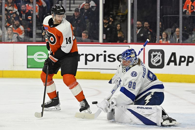 Jan 23, 2024; Philadelphia, Pennsylvania, USA; Tampa Bay Lightning goaltender Andrei Vasilevskiy (88) makes a save against Philadelphia Flyers center Sean Couturier (14) during the first period  Wells Fargo Center. Mandatory Credit: Eric Hartline-USA TODAY Sports