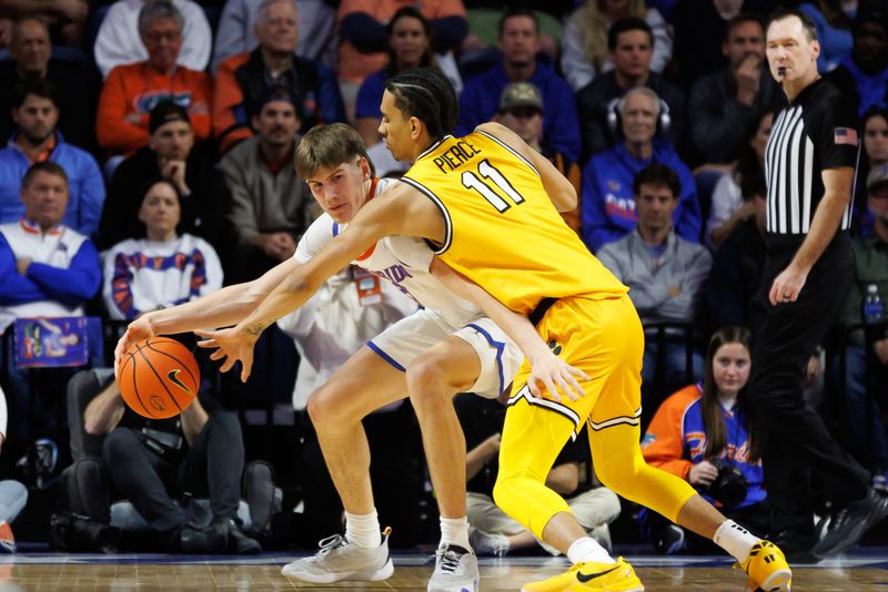 Jan 14, 2025; Gainesville, Florida, USA; Missouri Tigers guard Trent Pierce (11) reaches for the ball over the shoulder of Florida Gators forward Alex Condon (21) during the first half at Exactech Arena at the Stephen C. O'Connell Center. Mandatory Credit: Matt Pendleton-Imagn Images