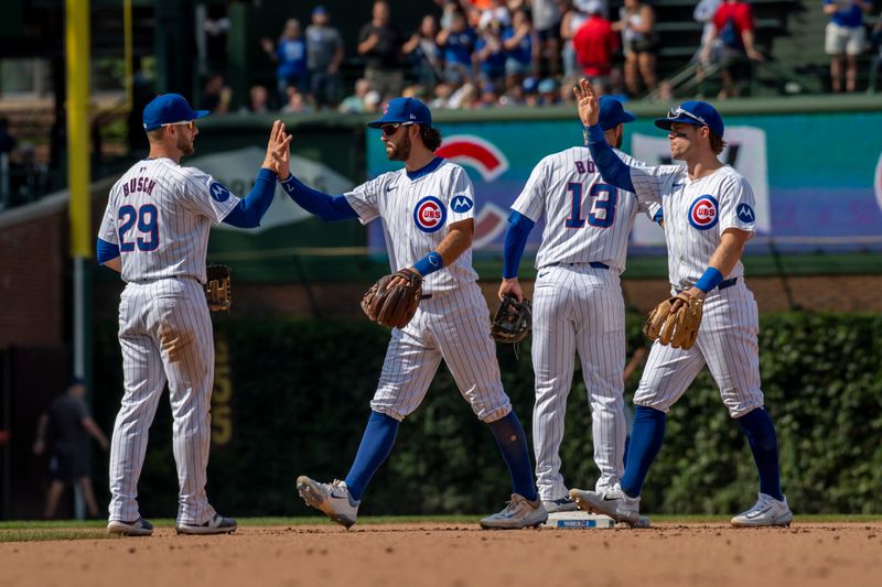 Aug 22, 2024; Chicago, Illinois, USA; The Chicago Cubs celebrate after defeating the Detroit Tigers at Wrigley Field. Mandatory Credit: Patrick Gorski-USA TODAY Sports