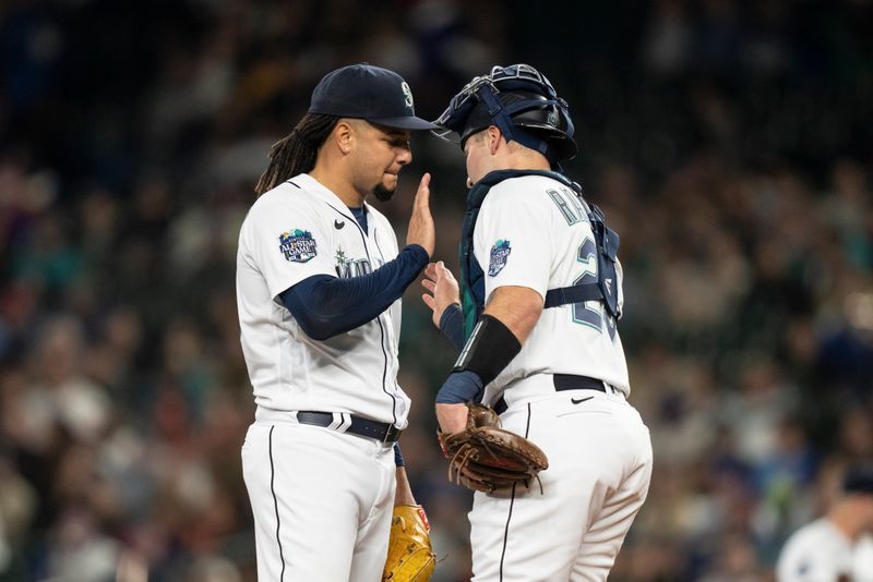 Apr 22, 2023; Seattle, Washington, USA; Seattle Mariners starting pitcher Luis Castillo (58), left, and catcher Cal Raleigh (29) meet at the mound during the first inning against the St. Louis Cardinals at T-Mobile Park. Mandatory Credit: Stephen Brashear-USA TODAY Sports