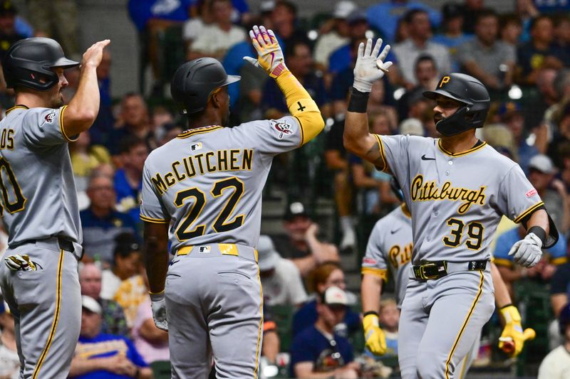 Jun 24, 2025; Milwaukee, Wisconsin, USA;  Pittsburgh Pirates second baseman Nick Gonzales is greeted by  designated hitter Andrew McCutchen (22) and right fielder Bryan Reynolds (10) after hitting a three-run home run in the sixth inning against the Milwaukee Brewers at American Family Field. Mandatory Credit: Benny Sieu-Imagn Images