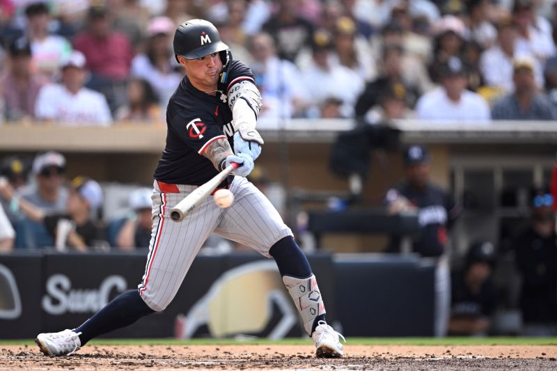 Aug 21, 2024; San Diego, California, USA; Minnesota Twins third baseman Jose Miranda (64) hits a single during the third inning against the San Diego Padres at Petco Park. Mandatory Credit: Orlando Ramirez-USA TODAY Sports