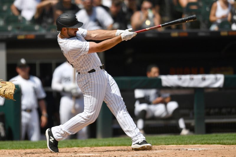 Jun 29, 2024; Chicago, Illinois, USA; Chicago White Sox shortstop Paul DeJong (29) hits a two-run home run during the sixth inning against the Colorado Rockies at Guaranteed Rate Field. Mandatory Credit: Patrick Gorski-USA TODAY Sports