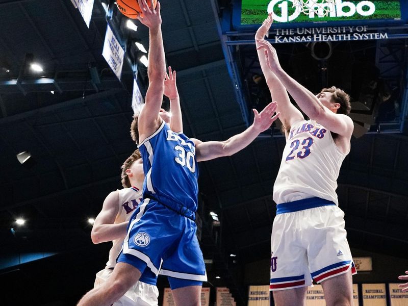 Feb 27, 2024; Lawrence, Kansas, USA; Brigham Young Cougars guard Dallin Hall (30) shoots as Kansas Jayhawks forward Parker Braun (23) defends during the second half at Allen Fieldhouse. Mandatory Credit: Denny Medley-USA TODAY Sports