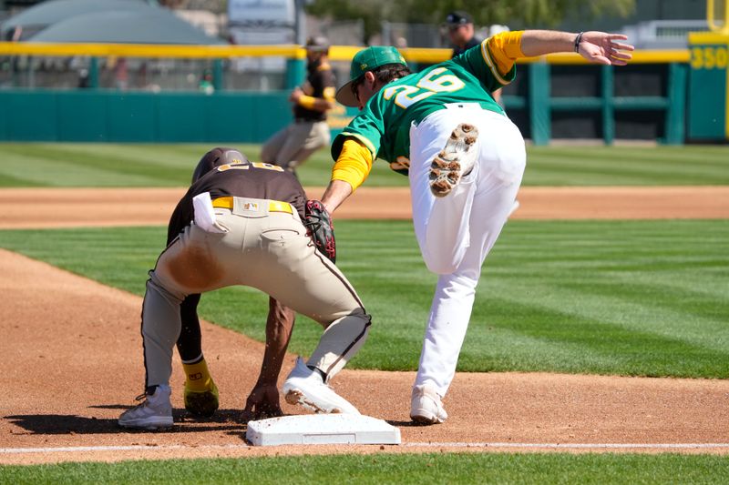 Mar 12, 2023; Mesa, Arizona, USA; Oakland Athletics third baseman Jonah Bride (26) puts a late tag on San Diego Padres right fielder Jose Azocar (28) in the first inning at Hohokam Stadium. Mandatory Credit: Rick Scuteri-USA TODAY Sports