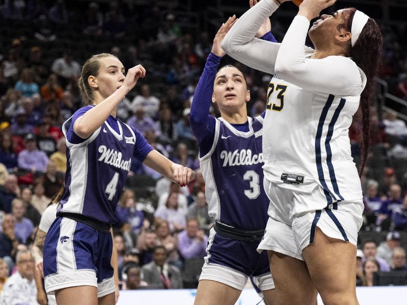 Mar 7, 2025; Kansas City, MO, USA; West Virginia Mountaineers forward Jordan Thomas (23) shoots the ball while defended by Kansas State Wildcats guard Serena Sundell (4) and guard Jaelyn Glenn (3) in the first quarter at T-Mobile Center. Mandatory Credit: Amy Kontras-Imagn Images