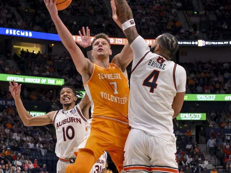 Mar 15, 2025; Nashville, TN, USA;  Tennessee Volunteers forward Igor Milicic Jr. (7) lays the ball in over Auburn Tigers forward Johni Broome (4) during the first half at Bridgestone Arena. Mandatory Credit: Steve Roberts-Imagn Images