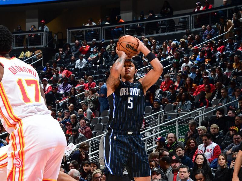 ATLANTA, GA - JANUARY 17: Paolo Banchero #5 of the Orlando Magic shoots a three point basket during the game  on January 17, 2024 at State Farm Arena in Atlanta, Georgia.  NOTE TO USER: User expressly acknowledges and agrees that, by downloading and/or using this Photograph, user is consenting to the terms and conditions of the Getty Images License Agreement. Mandatory Copyright Notice: Copyright 2024 NBAE (Photo by Scott Cunningham/NBAE via Getty Images)