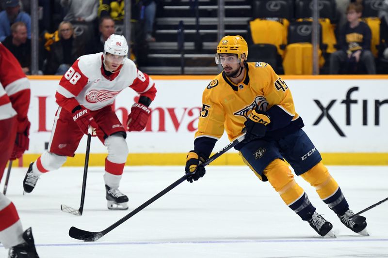 Mar 23, 2024; Nashville, Tennessee, USA; Nashville Predators defenseman Alexandre Carrier (45) skates with the puck during the first period against the Detroit Red Wings at Bridgestone Arena. Mandatory Credit: Christopher Hanewinckel-USA TODAY Sports