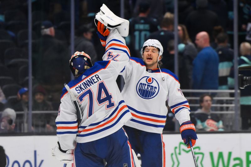 Mar 2, 2024; Seattle, Washington, USA; Edmonton Oilers goaltender Stuart Skinner (74) and defenseman Vincent Desharnais (73) celebrate defeating the Seattle Kraken at Climate Pledge Arena. Mandatory Credit: Steven Bisig-USA TODAY Sports