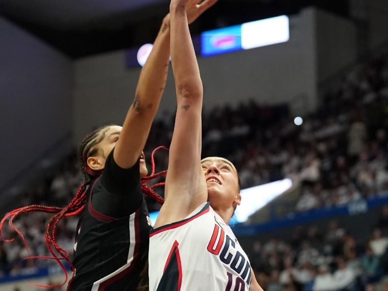 Feb 5, 2023; Hartford, Connecticut, USA; UConn Huskies guard Nika Muhl (10) shoots against South Carolina Gamecocks forward Victaria Saxton (5) in the first half at XL Center. Mandatory Credit: David Butler II-USA TODAY Sports