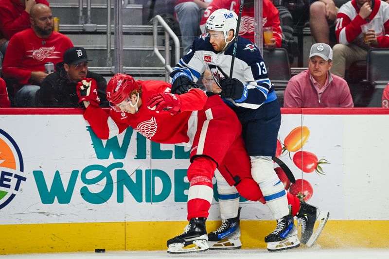 Oct 30, 2024; Detroit, Michigan, USA; Winnipeg Jets center Gabriel Vilardi (13) and Detroit Red Wings defenseman Simon Edvinsson (77) battle for the puck during the first period at Little Caesars Arena. Mandatory Credit: Tim Fuller-Imagn Images