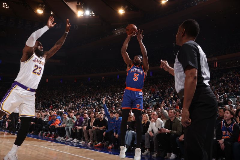 NEW YORK, NY - FEBRUARY 3: Precious Achiuwa #5 of the New York Knicks shoots a three point basket over LeBron James #23 of the Los Angeles Lakers during the game on February 3, 2024 at Madison Square Garden in New York City, New York.  NOTE TO USER: User expressly acknowledges and agrees that, by downloading and or using this photograph, User is consenting to the terms and conditions of the Getty Images License Agreement. Mandatory Copyright Notice: Copyright 2024 NBAE  (Photo by Nathaniel S. Butler/NBAE via Getty Images)