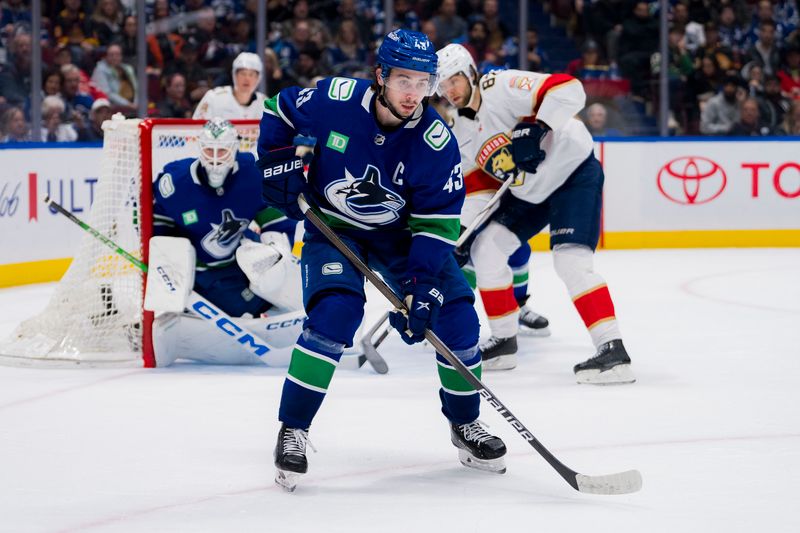 Dec 14, 2023; Vancouver, British Columbia, CAN; Vancouver Canucks defenseman Quinn Hughes (43) defends on the penalty kill against the Florida Panthers in the second period at Rogers Arena. Mandatory Credit: Bob Frid-USA TODAY Sports