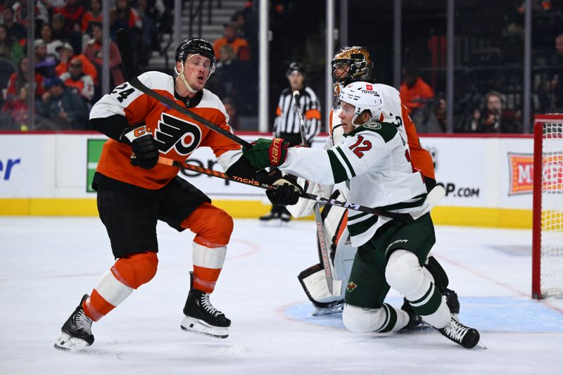 Oct 26, 2024; Philadelphia, Pennsylvania, USA; Philadelphia Flyers defenseman Nick Seeler (24) and Minnesota Wild left wing Matt Boldy (12) battle for position in the second period at Wells Fargo Center. Mandatory Credit: Kyle Ross-Imagn Images